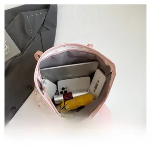 Interior view of large pink tote bag showing storage for laptop, phone and umbrella