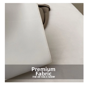 Close-up of fine leather texture and precise stitching on a minimalist tote bag