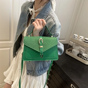 Fashionable bright green crossbody bag with glitter fabric contrast and gold buckle