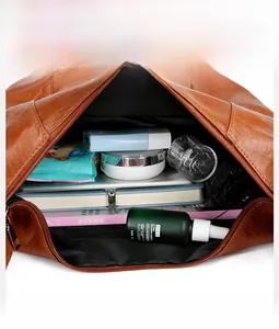 Detail view of brown pebbled leather bag showing large capacity interior compartments