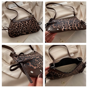 Detail view of leopard print crescent bag featuring bow drawstring and rivet accents