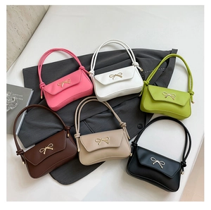 Detailed close-up of colorful women's bow bags with woven handles and gold metal hardware
