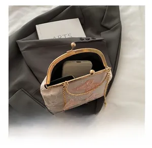 Detailed view of vintage embroidered handbag showing internal space for a smartphone