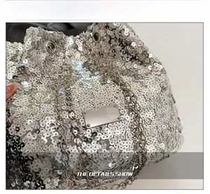 Macro shot of shimmering silver sequins and premium metal chain strap on a stylish bucket bag