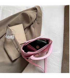 Overhead view showing spacious interior and zip pocket of pink bow bucket handbag