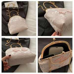 Detail of French lace handbag with 3D butterfly accents and gold metal kiss-lock frame