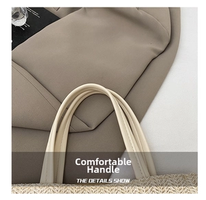 Detail of soft rounded handle and tightly woven texture on a straw bucket handbag