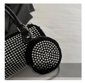 Close-up of black cylinder bag set featuring sparkling silver rhinestones and chain strap