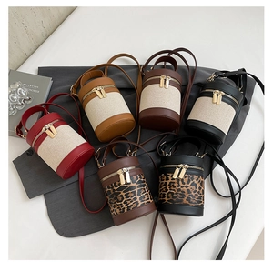 Top view of cylindrical canvas bucket bags in various colors with twin zipper closures
