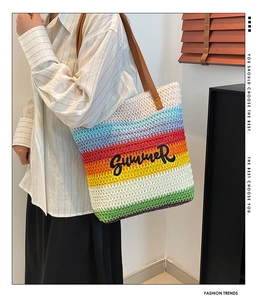 Close-up of rainbow woven tote bag with Summer embroidery and brown leather straps