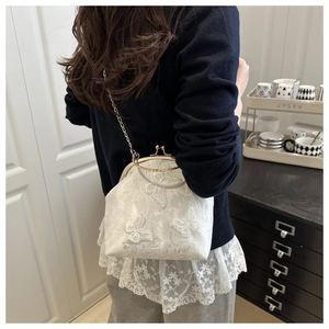 White shell handbag featuring detailed 3D butterfly embroidery and elegant metal chain