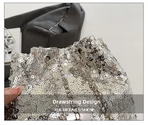 Close-up of drawstring design on silver sequin bucket bag with metal chain and eyelets