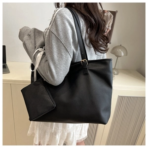 Détail du sac cabas en cuir Saffiano noir avec petite pochette et boucles dorées
