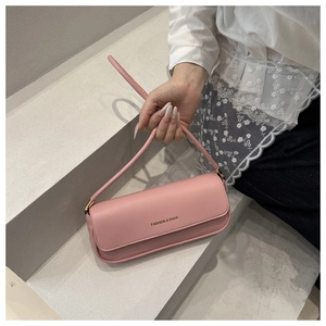 Detail of pink PU leather shoulder bag featuring gold Fashion & Bags lettering on flap