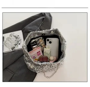 Spacious silver sequin chain bag interior showing storage for phone and makeup