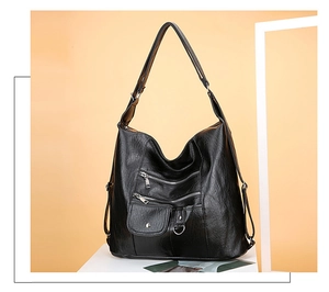 Detail of vintage black soft leather hobo bag with multiple functional zipper pockets