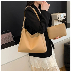 Chic ginger leather tote bag set shown with a model in a modern office setting