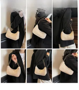 Multi-angle views of beige woven baguette bag with gold chain strap on model