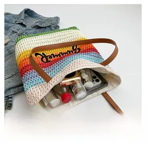 Rainbow striped straw tote bag showing spacious interior with everyday essentials