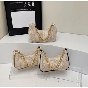 Close-up of woven straw texture and gold chain straps on stylish baguette shoulder bags