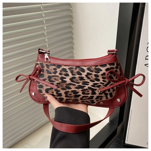 Detail of burgundy PU leather and leopard print underarm bag with sweet double bows