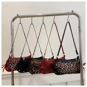 Detailed view of leopard print and vintage bows on five colorful shoulder bags