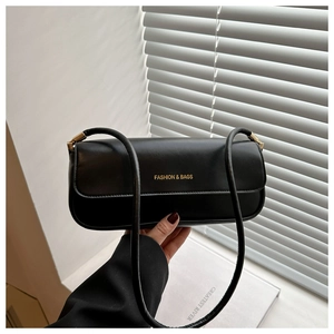 Detail of black rectangular shoulder bag with golden FASHION & BAGS logo and sleek straps