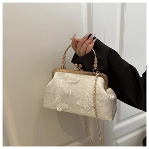 Détail du sac à main blanc élégant avec broderie papillon 3D et cadre en métal doré