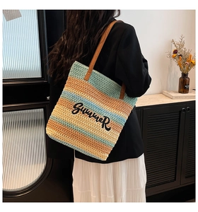 Detail of multi-color woven beach tote with Summer embroidery and brown shoulder straps
