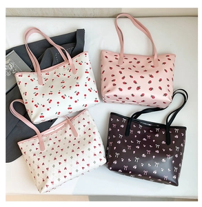 Flat lay view of four stylish tote bags with cherry, berry, and floral prints on white bedding