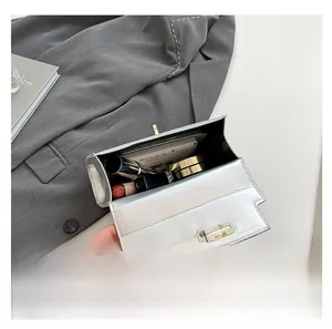 Silver leather handbag interior showing capacity for lipstick, phone, and makeup essentials