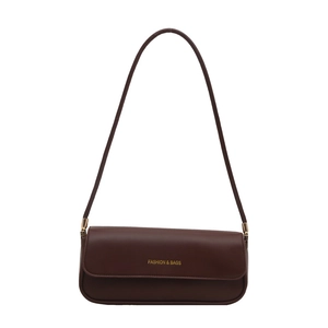 Minimalist dark brown leather baguette shoulder bag with gold lettering and slim strap