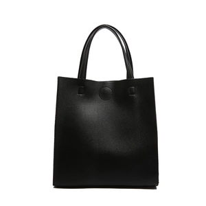 Minimalist black tote bag in pebbled leather with a vertical silhouette and top handles