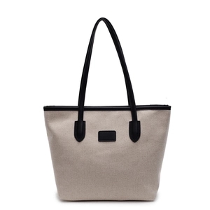 Minimalist beige canvas tote bag with black leather trim and long shoulder straps