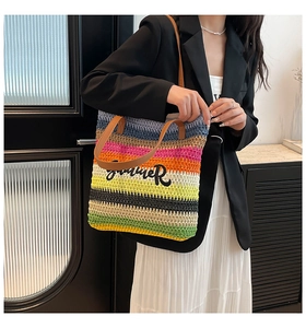Detail of colorful striped woven tote with Summer embroidery and brown leather strap