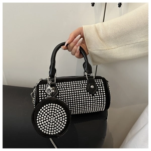 Detail of black rhinestone barrel bag with matching mini coin purse and silver chain strap