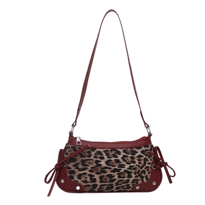 Leopard print crossbody bag with deep red leather trim and side ribbon details