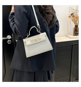 Detail of silver sequin crossbody bag with gold twist lock and smooth leather flap