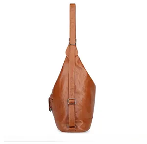 Close-up of cognac brown crossbody bag showing side zipper pocket and silver buckle