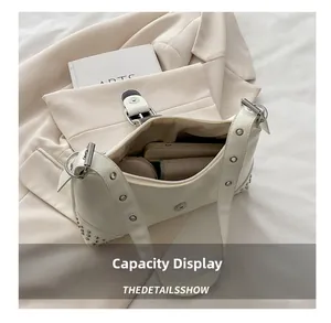 Internal capacity view of cream leather tote bag with silver studs and metal eyelets