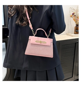 Detailed side view of pink sequin patchwork handbag worn by model in elegant home setting