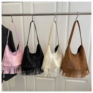 Detail of four tassel shoulder bags in pink black cream and brown with lychee texture