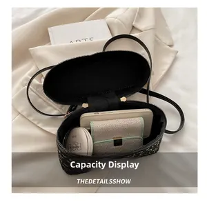 Interior view showing small tweed bag capacity with phone and cosmetics inside