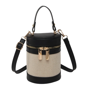 Contrast color bucket bag in canvas and leather with gold zippers and adjustable strap