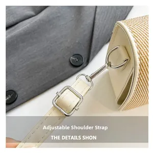 Detail showing the adjustable beige leather strap with silver buckle on a woven handbag