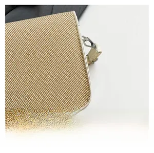 Macro shot of textured woven fabric with cream leather trim and silver metal hardware detail