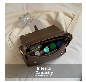 Internal capacity of dark brown vintage square bag showing storage for daily items