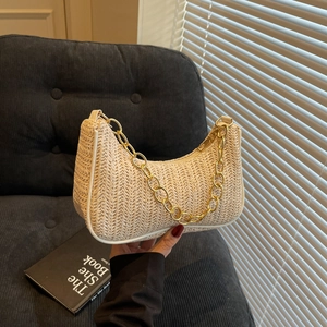Minimalist crescent straw tote with white leather trim and bold gold chain strap details