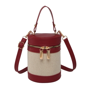 Contrast color cylinder bucket bag in red leather and beige woven fabric with dual zippers