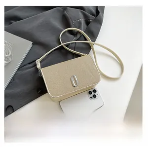 Close-up of beige woven crossbody bag with silver buckle and phone for size reference